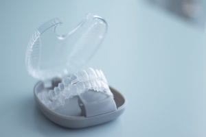 Clear aligners sitting in their protective case