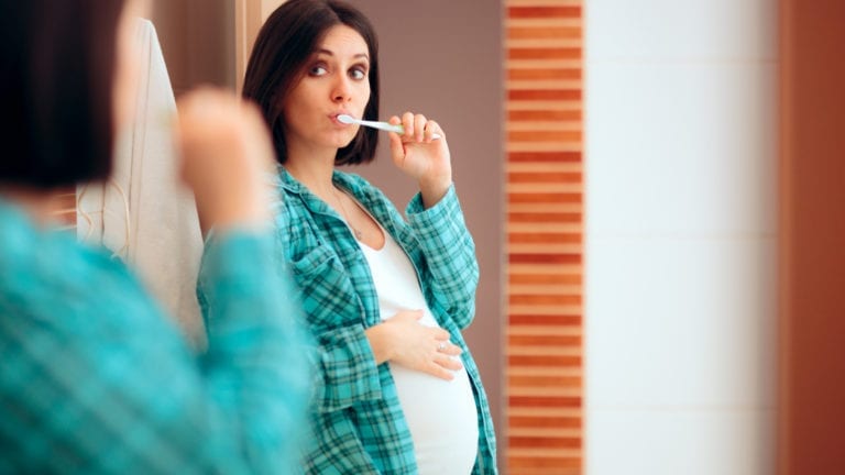 Pregnant Woman Brushing Teeth