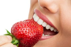 mouth biting into a strawberry