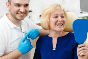 woman looking in mirror at dentist's office